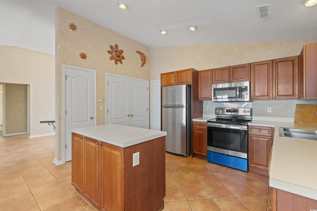 kitchen featuring light tile patterned floors, visible vents, appliances with stainless steel finishes, and vaulted ceiling