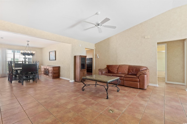 living room with lofted ceiling, light tile patterned flooring, ceiling fan with notable chandelier, and baseboards