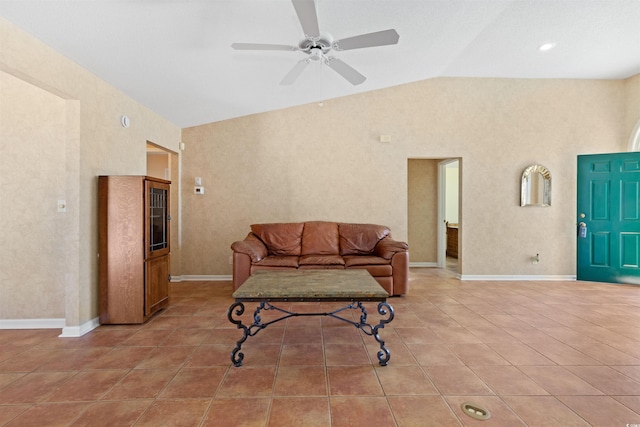 tiled living area featuring baseboards, lofted ceiling, and ceiling fan