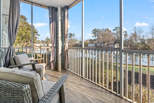 sunroom / solarium featuring a water view