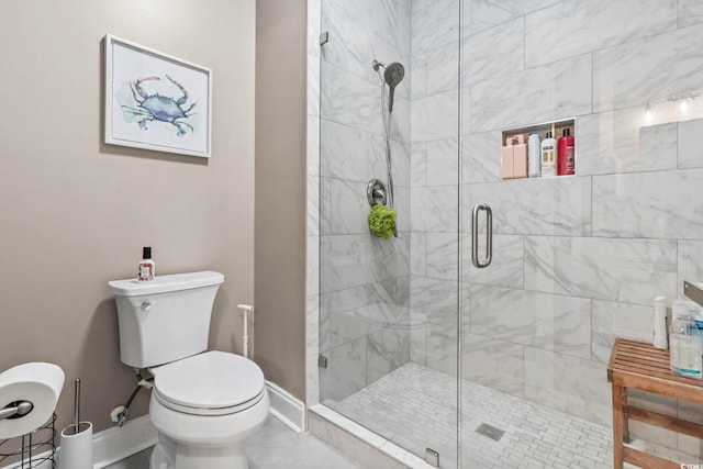 full bath with a shower stall, toilet, and baseboards