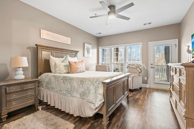 bedroom featuring dark wood-style flooring, visible vents, and access to outside