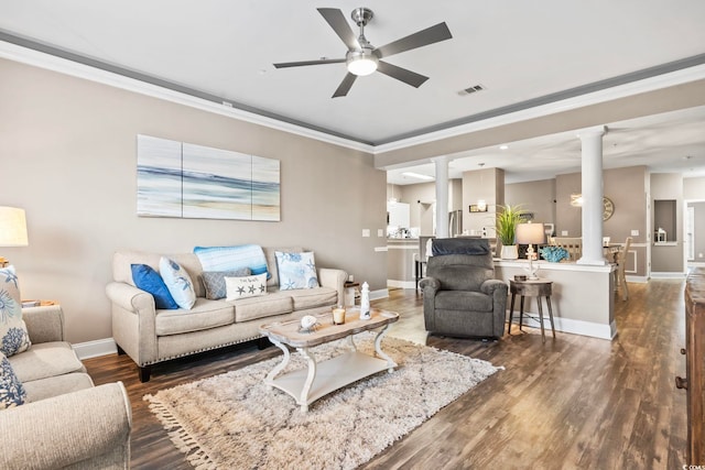 living room with visible vents, ornamental molding, ornate columns, wood finished floors, and a ceiling fan