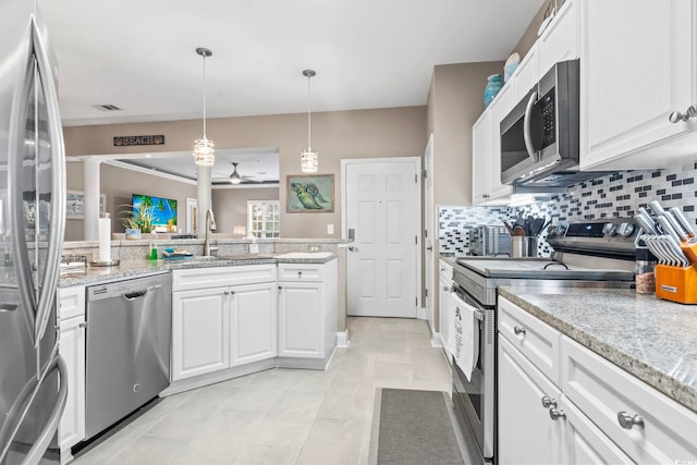 kitchen with tasteful backsplash, appliances with stainless steel finishes, ceiling fan, and white cabinetry