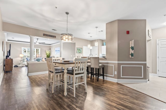 dining area featuring visible vents, baseboards, wood finished floors, and a ceiling fan