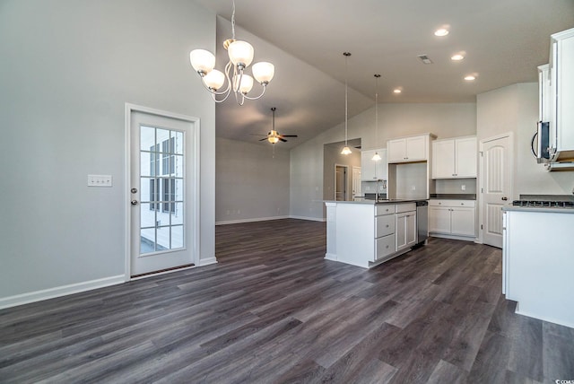 kitchen with dark countertops, ceiling fan with notable chandelier, open floor plan, and dark wood-style flooring