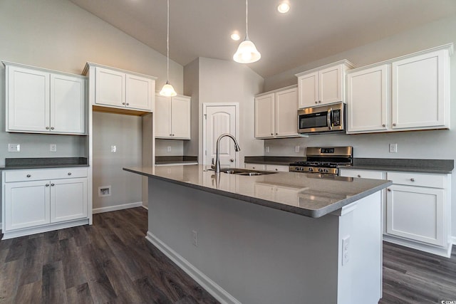 kitchen with a center island with sink, a sink, dark wood-style floors, white cabinetry, and stainless steel appliances