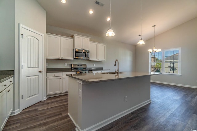 kitchen featuring visible vents, lofted ceiling, stainless steel appliances, white cabinetry, and a sink