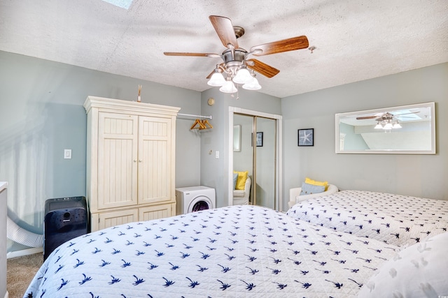 bedroom featuring a textured ceiling, a closet, carpet, washer / dryer, and ceiling fan