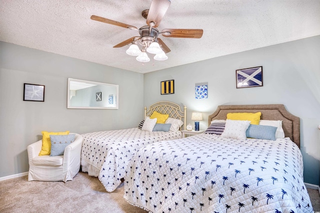 carpeted bedroom featuring ceiling fan, baseboards, and a textured ceiling