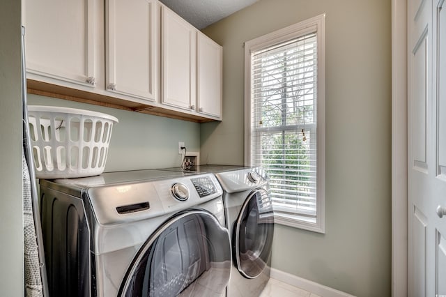 laundry area with cabinet space, baseboards, and washing machine and clothes dryer