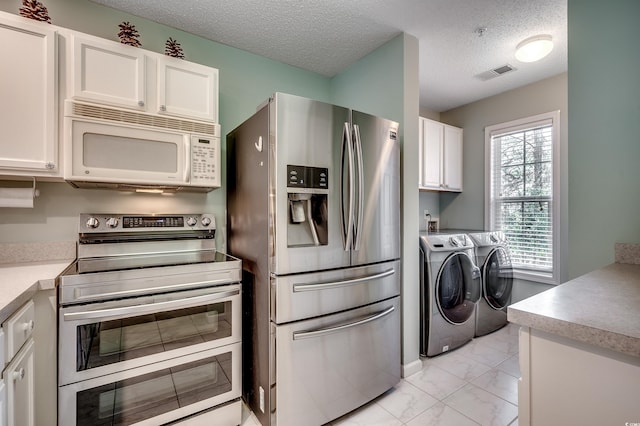 kitchen with visible vents, stainless steel appliances, marble finish floor, white cabinetry, and separate washer and dryer