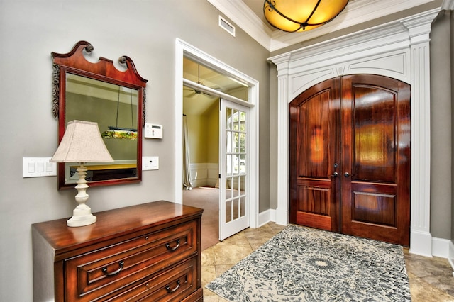 foyer featuring visible vents, french doors, and crown molding