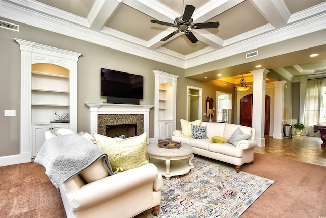 living room featuring visible vents, carpet flooring, a ceiling fan, and ornate columns