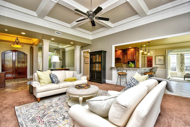 carpeted living area featuring visible vents, ceiling fan, beam ceiling, coffered ceiling, and ornate columns