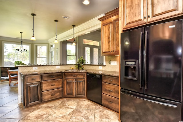 kitchen with light stone counters, a peninsula, a sink, black appliances, and tasteful backsplash