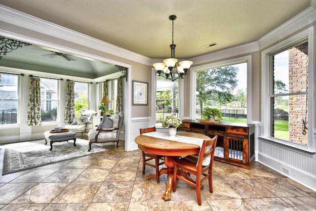 dining area featuring a wainscoted wall, crown molding, a notable chandelier, and visible vents