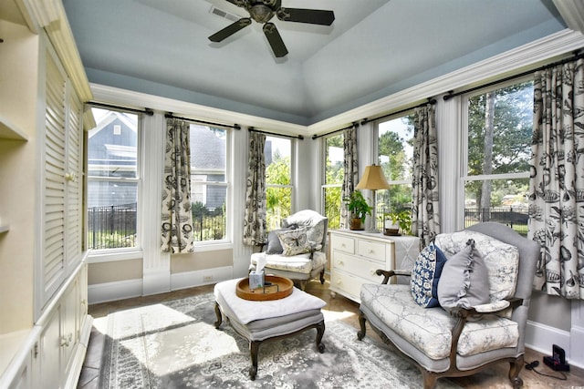 sunroom with visible vents, a ceiling fan, and vaulted ceiling