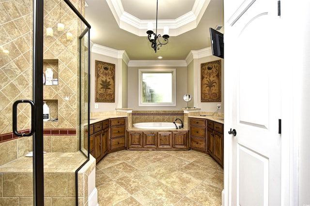 bathroom with crown molding, a tray ceiling, a stall shower, a bath, and vanity