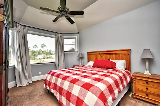 carpeted bedroom with a ceiling fan, baseboards, and vaulted ceiling