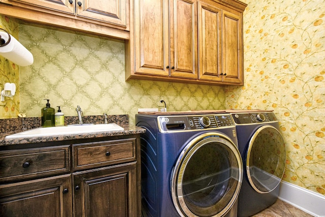 laundry room featuring a sink, cabinet space, and wallpapered walls