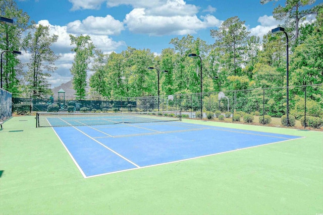 view of sport court with fence