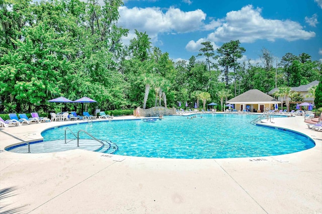 pool featuring a patio and fence