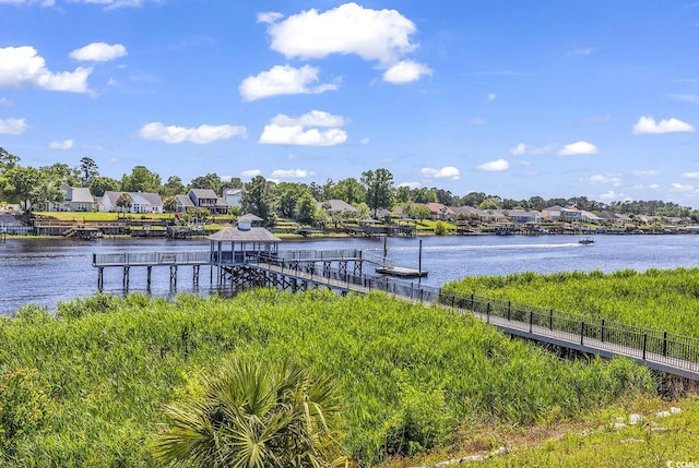 dock area with a residential view and a water view