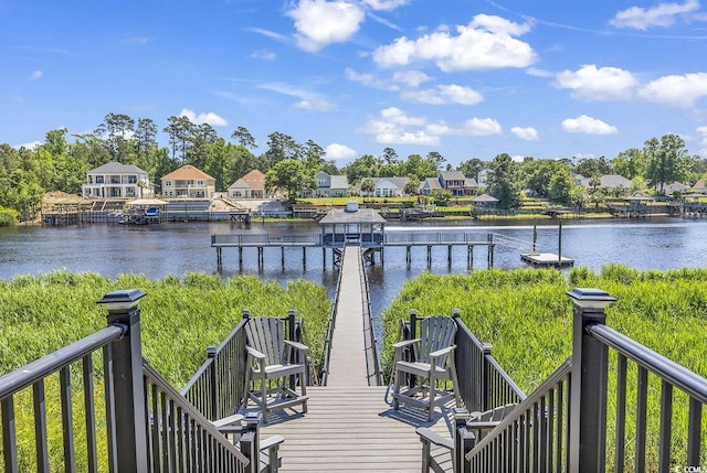 wooden terrace with a dock, a water view, and a residential view