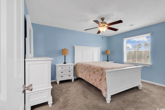 carpeted bedroom featuring visible vents, baseboards, and a ceiling fan