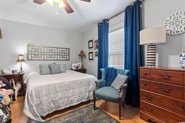 bedroom with a ceiling fan and wood finished floors