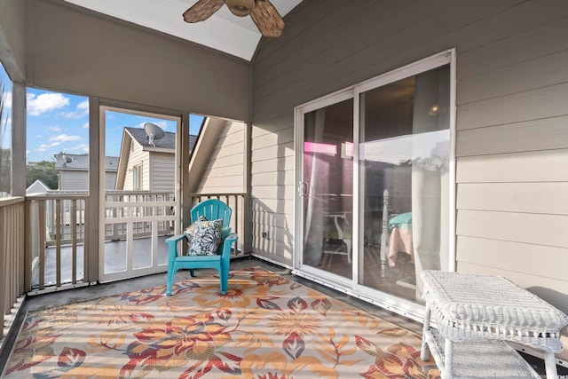 sunroom featuring lofted ceiling and ceiling fan