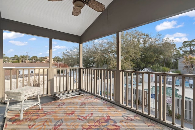 sunroom / solarium with a ceiling fan and vaulted ceiling