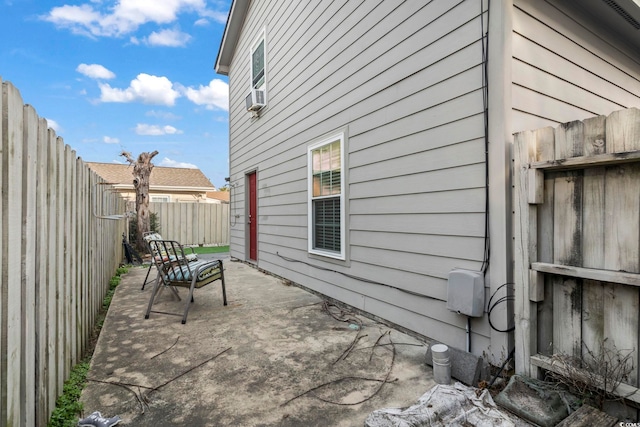 view of patio / terrace featuring cooling unit and a fenced backyard