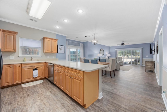 kitchen featuring visible vents, a peninsula, a sink, light countertops, and stainless steel dishwasher