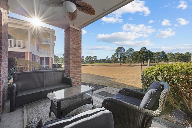 view of patio with an outdoor living space and ceiling fan