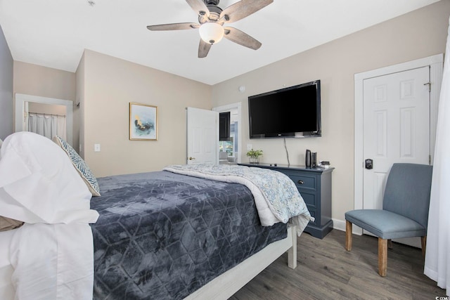 bedroom with ceiling fan, baseboards, and wood finished floors