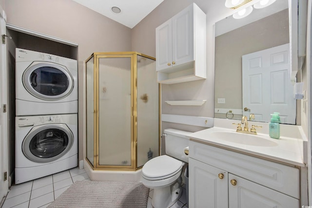 full bath with tile patterned flooring, a shower stall, stacked washing maching and dryer, and vanity