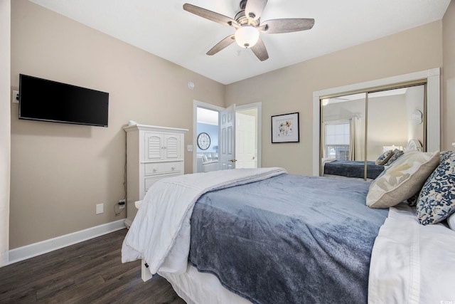 bedroom with a closet, baseboards, dark wood finished floors, and a ceiling fan