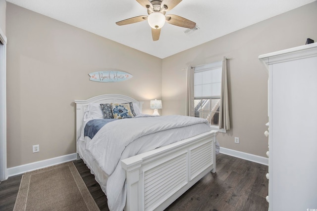 bedroom with visible vents, baseboards, dark wood-type flooring, and a ceiling fan