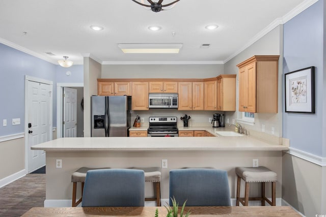 kitchen with ornamental molding, a sink, stainless steel appliances, a peninsula, and light countertops