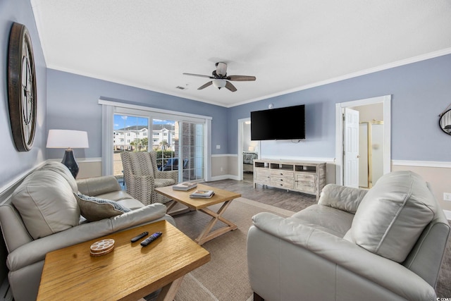 living room with visible vents, crown molding, ceiling fan, and wood finished floors