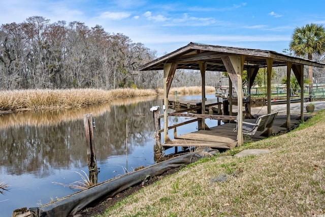 dock area with a water view and boat lift