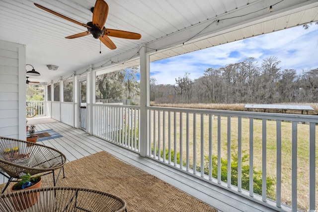 sunroom / solarium featuring ceiling fan