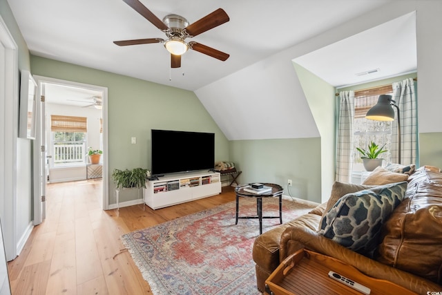 living room featuring wood finished floors, baseboards, visible vents, ceiling fan, and vaulted ceiling