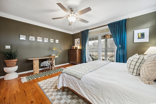 bedroom featuring access to exterior, ceiling fan, baseboards, ornamental molding, and wood finished floors