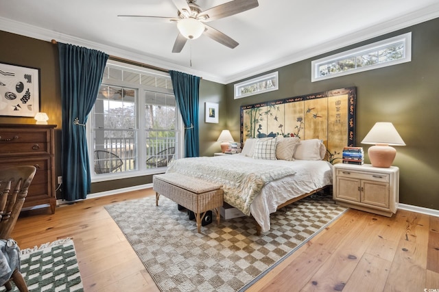 bedroom featuring crown molding, multiple windows, light wood-style floors, and ceiling fan