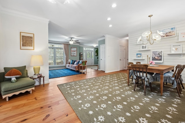 dining room with wood finished floors, baseboards, recessed lighting, ornamental molding, and ceiling fan with notable chandelier