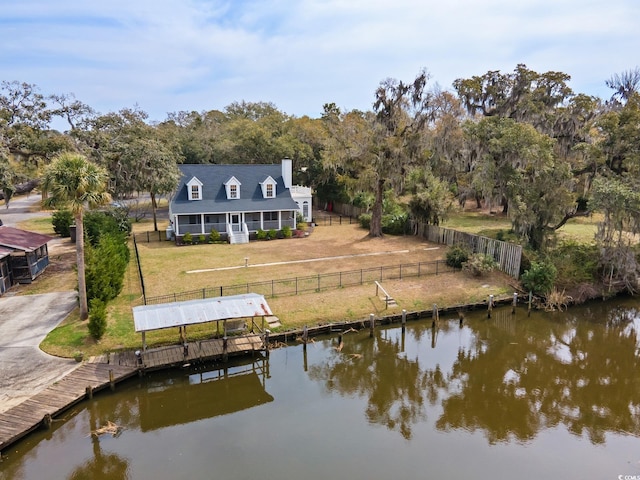 view of dock featuring a yard, a fenced backyard, and a water view