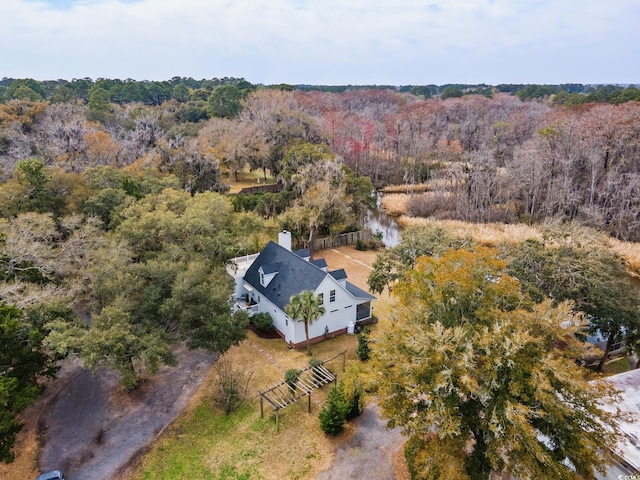 birds eye view of property with a wooded view